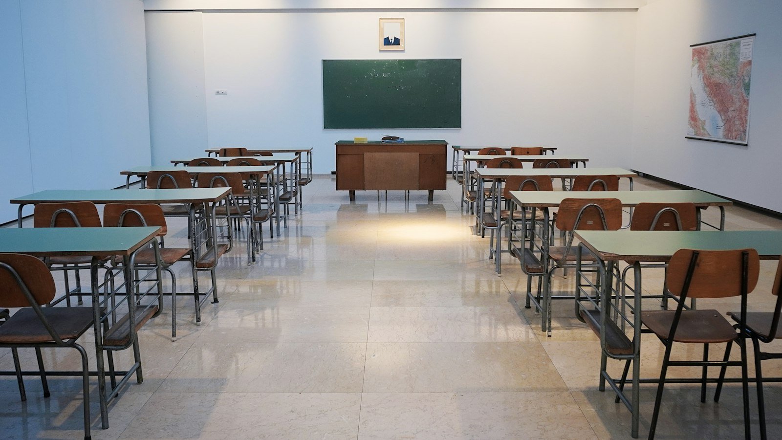 Pusta sala z ławkami i zieloną tablicą